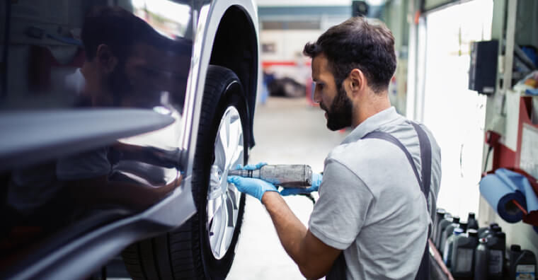 Mechanic working on car tire