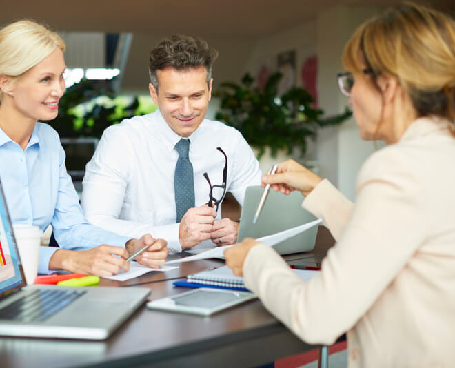 Woman consults with two customers on security solutions