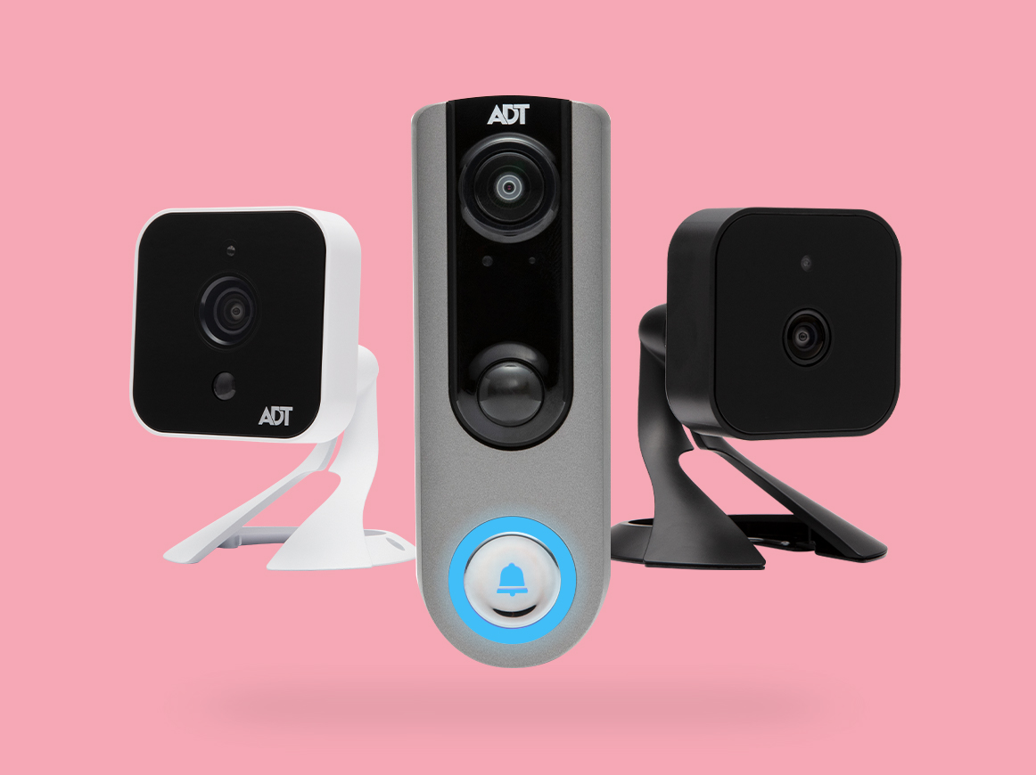 ADT white indoor camera, ADT doorbell, ADT black indoor camera againgt a pink background