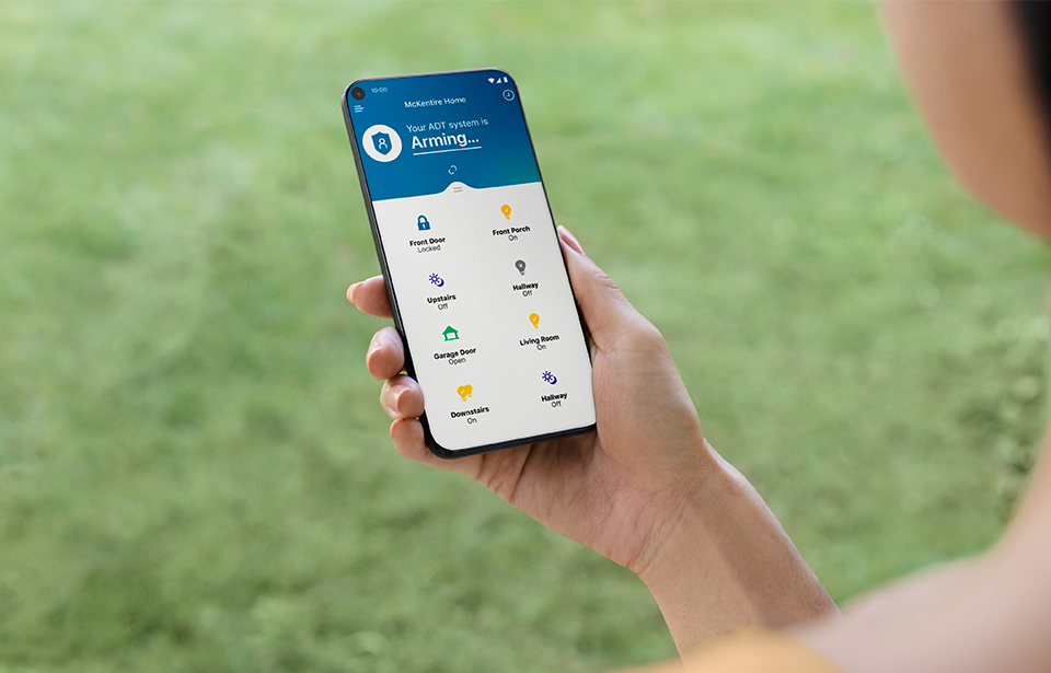 Someone using a cell phone with the ADT Control app