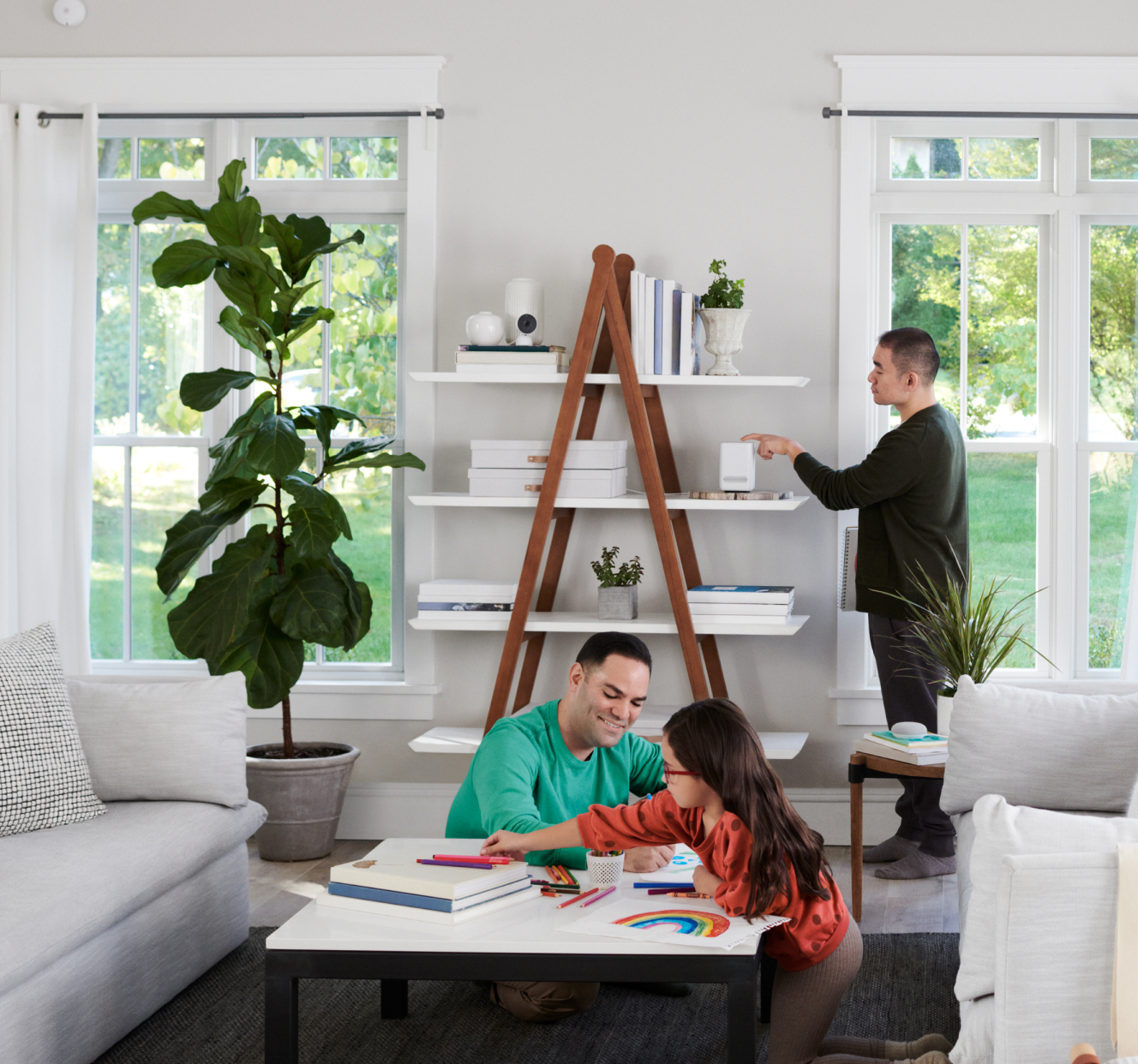 Family putting an ADT hub on a shelf