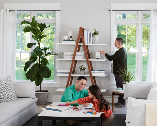 Family putting an ADT hub on a shelf