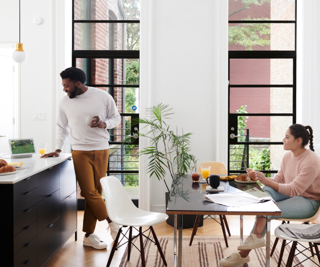 Couple in the kitchen with their ADT device