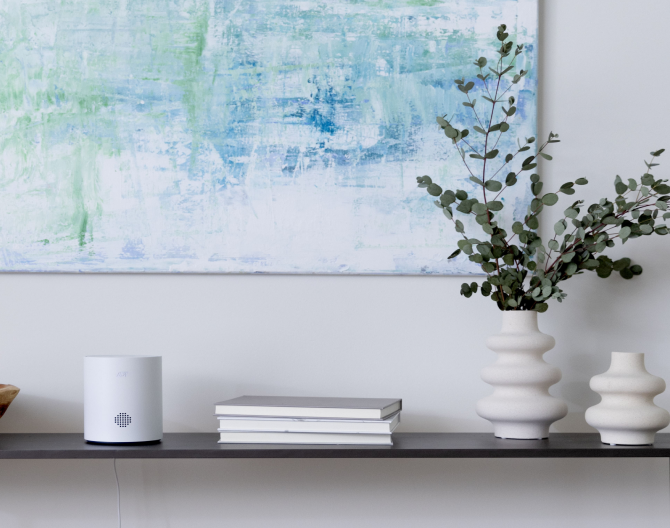 ADT Base on shelf in a home under a blue painting 