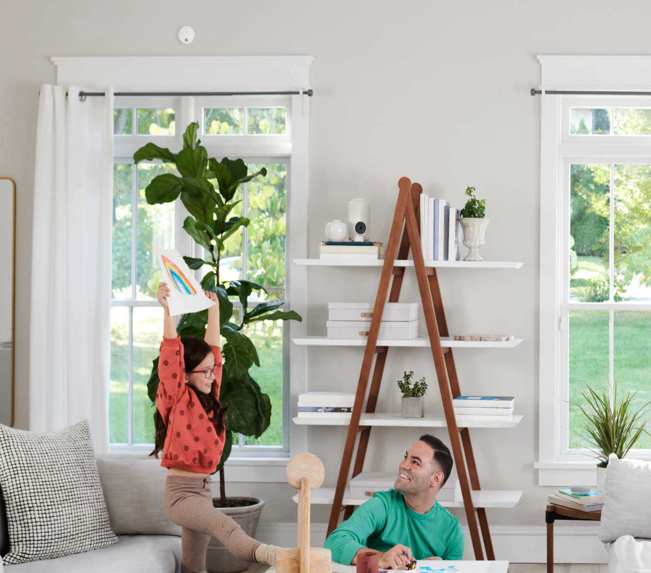 Family in the living room with ADT Carbon  Monoxide Detector mounted