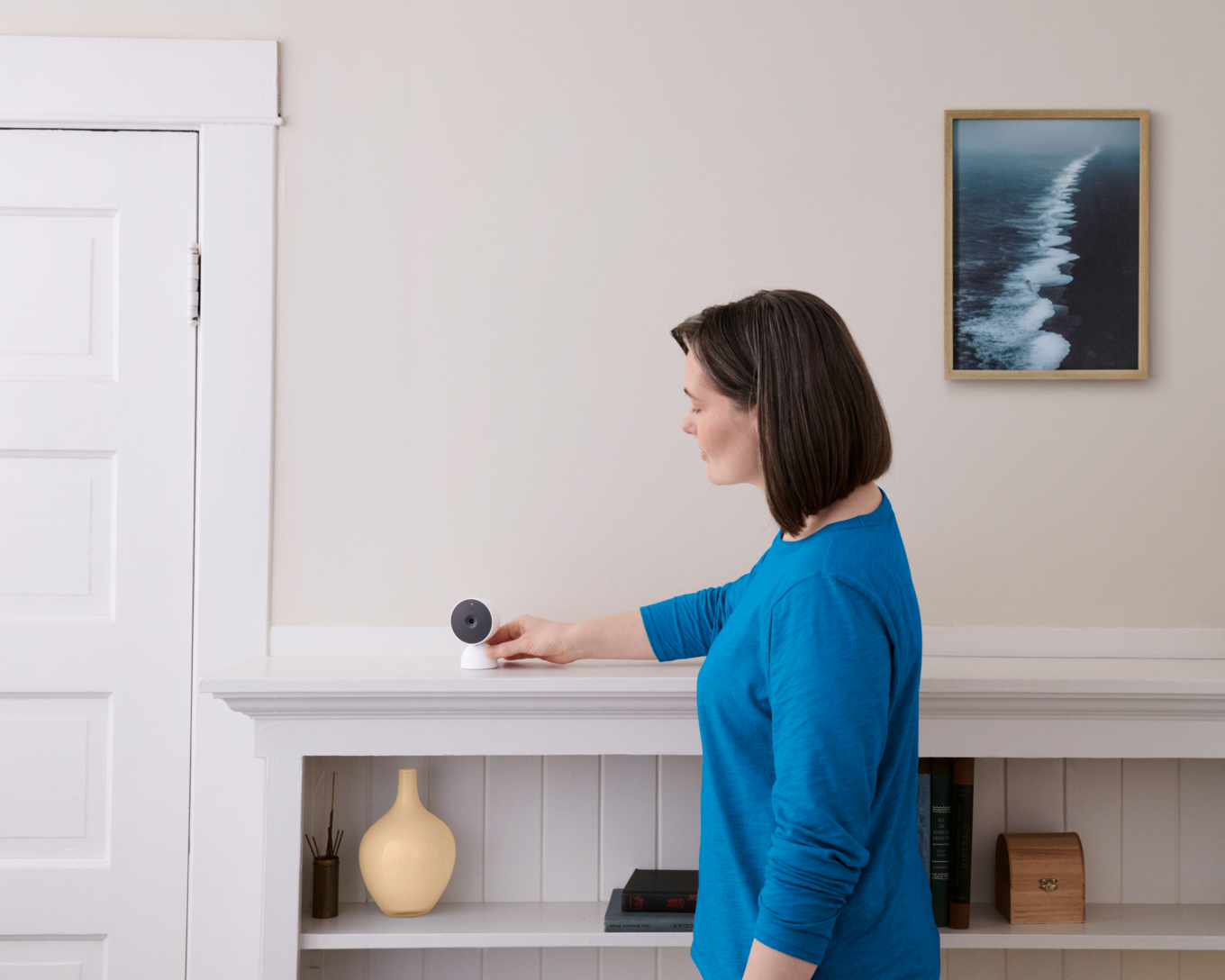 Women adjusting indoor camera in her home